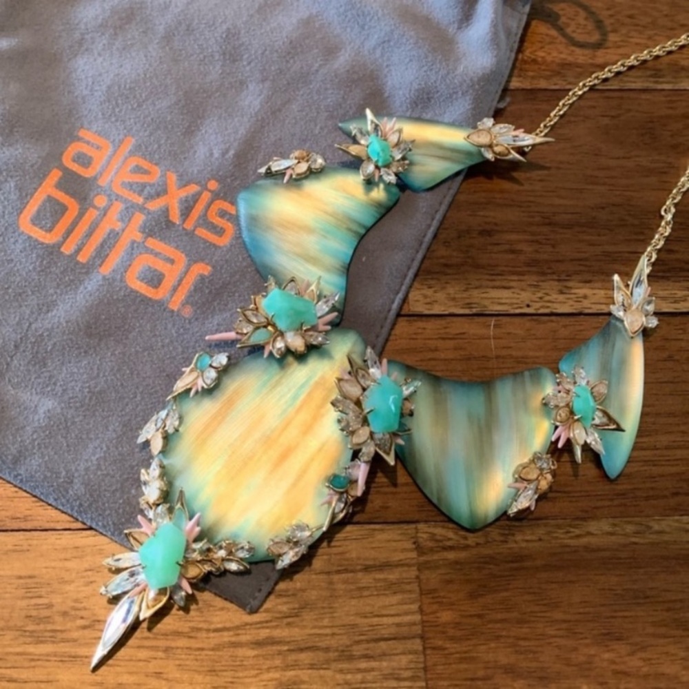 Alexis Bittar statement necklace in green color with multiple stones detailing.